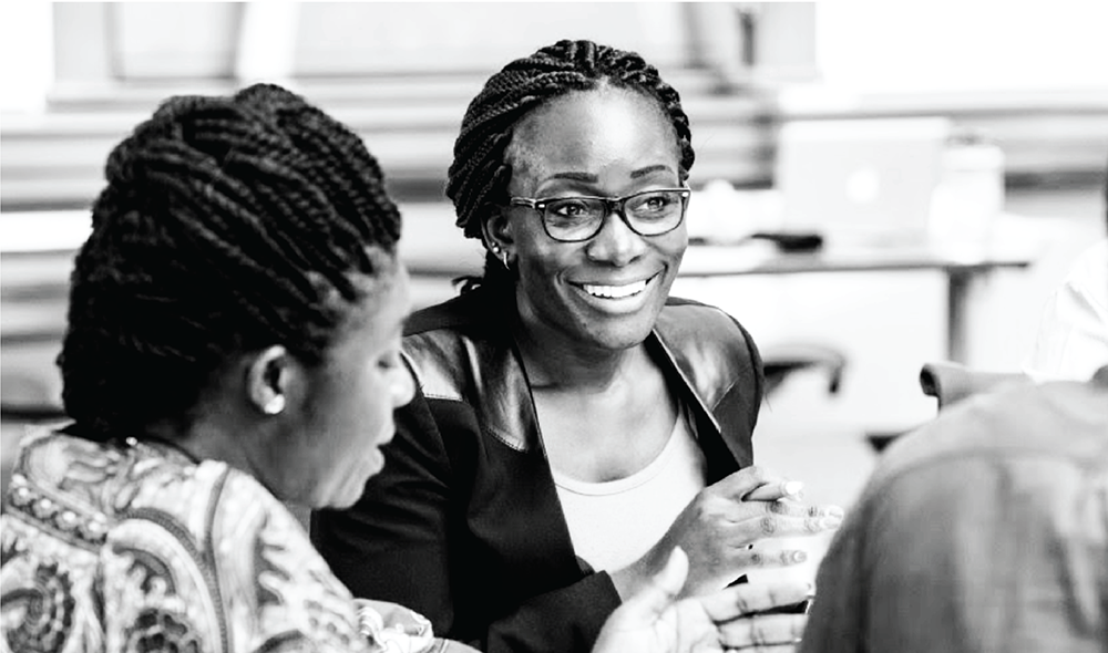 Dr. Wangia talking with coworkers