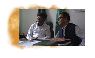 Dr. Dhimal sits around a table meeting with other researchers