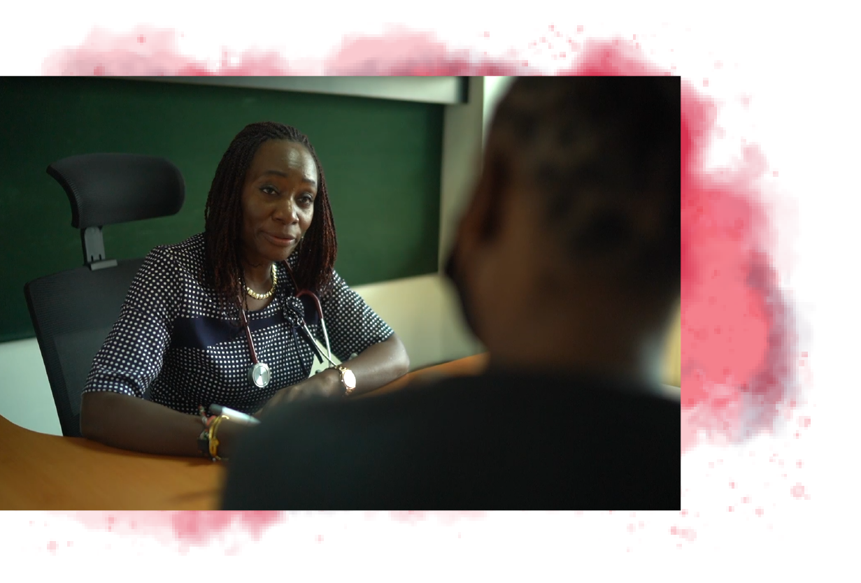 Dr. Wangia at a desk across from a patient