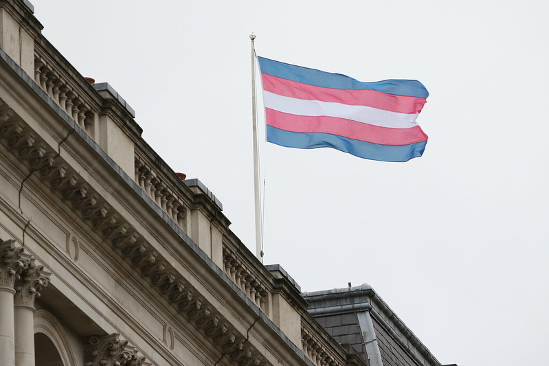 Transgender pride flag flying above a building
