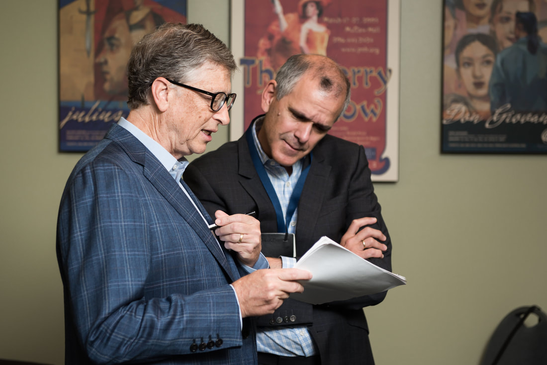 IHME director Chris Murray reviews a document with Bill Gates
