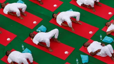 A photo of a group of men stretching and doing exercises