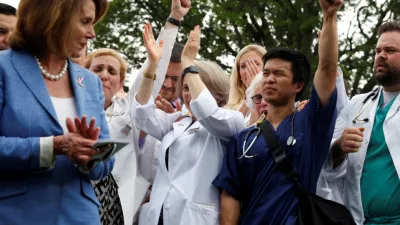 Healthcare workers react to remarks during an event protesting proposed healthcare legislation.