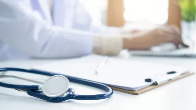 A stethoscope beside a health insurance form