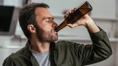 man drinking beer from a bottle