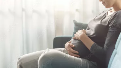 pregnant woman sitting on a sofa