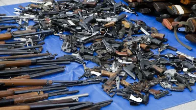 pile of miscellaneous guns on a tarp