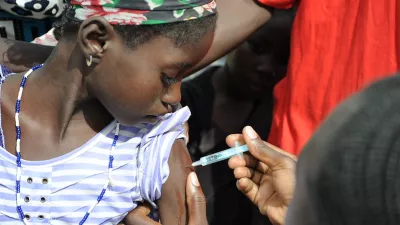 young girl receives a vaccine in Burkina Faso. Photo by WHO.