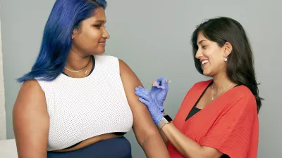 young woman about to receive a vaccine