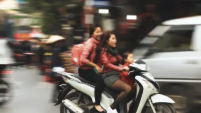 three young people ride on a motorcycle