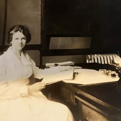 vintage portrait of Mary Dempsey working at a desk