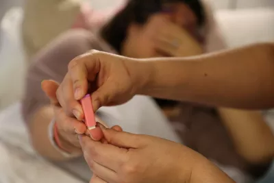 woman pricks finger for a blood test